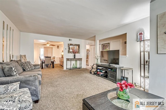 living room with carpet floors and ceiling fan