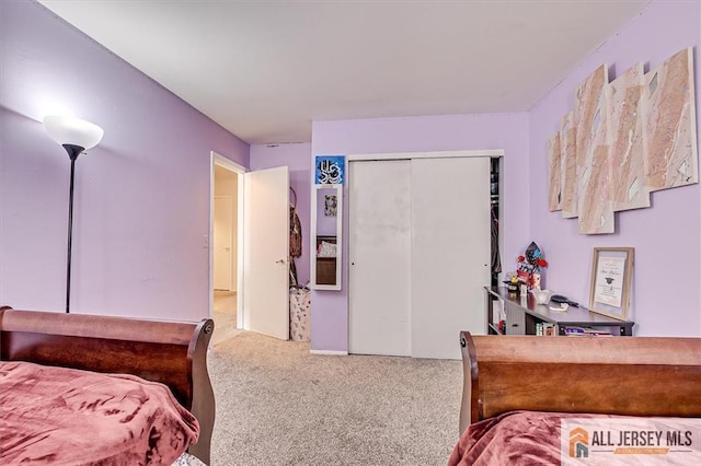 carpeted bedroom featuring a closet