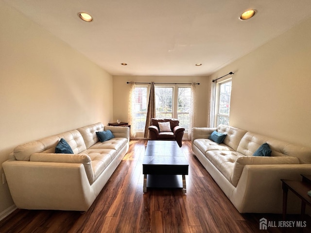 living room featuring recessed lighting, baseboards, and dark wood finished floors