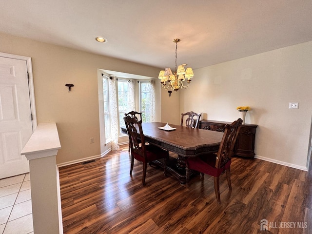 dining area with recessed lighting, baseboards, a notable chandelier, and wood finished floors