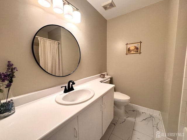 bathroom featuring visible vents, vanity, marble finish floor, toilet, and baseboards