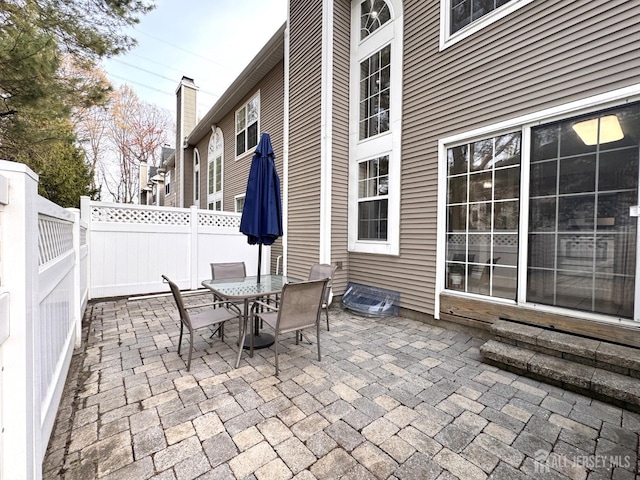 view of patio with fence and outdoor dining area