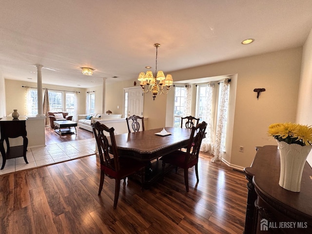 dining space featuring recessed lighting, baseboards, an inviting chandelier, and dark wood-style floors