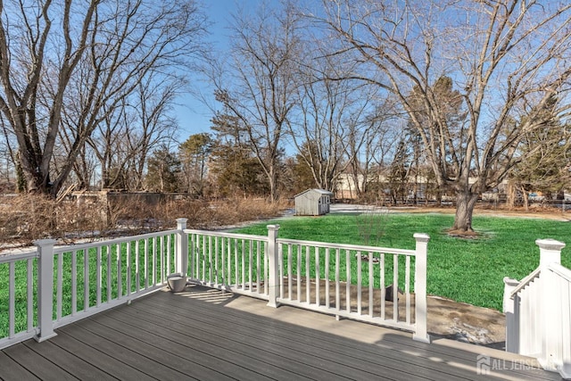 deck featuring a lawn and a storage unit