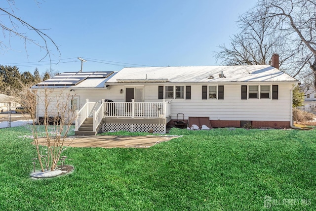 back of house with a yard and a deck