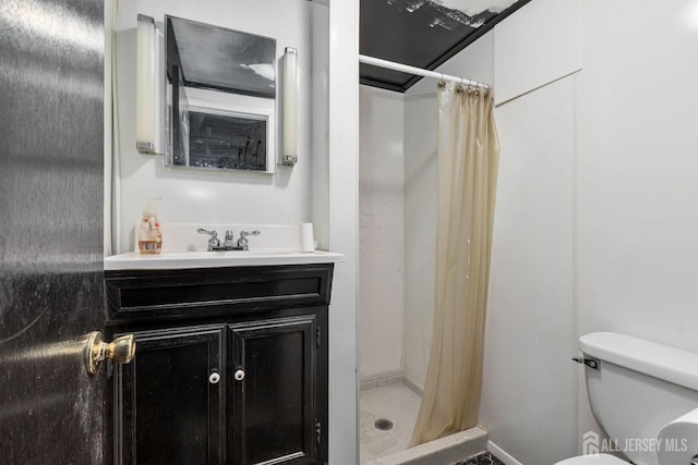 bathroom featuring walk in shower, vanity, and toilet