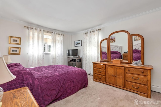 carpeted bedroom with a baseboard radiator and ornamental molding