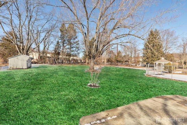 view of yard with a gazebo and a storage shed