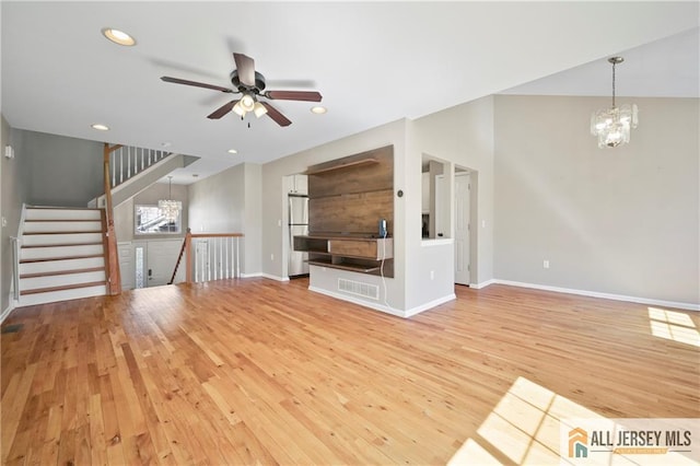 21 Capica Ct Unit 89, South Amboy, NJ 08879 - unfurnished living room featuring light wood-style floors, a chandelier, a ceiling fan, recessed lighting, and stairs