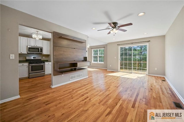 21 Capica Ct Unit 89, South Amboy, NJ 08879 - unfurnished living room with light wood-style flooring, ceiling fan, a chandelier, and recessed lighting