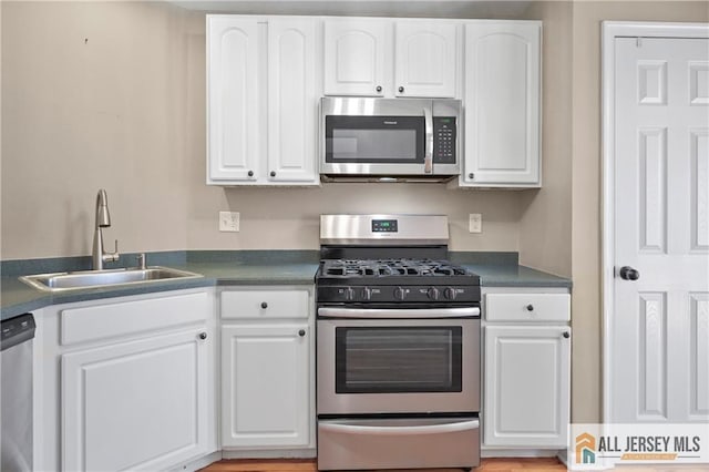 21 Capica Ct Unit 89, South Amboy, NJ 08879 - kitchen featuring stainless steel appliances, dark countertops, and white cabinets