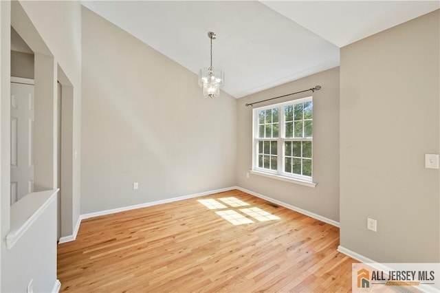 21 Capica Ct Unit 89, South Amboy, NJ 08879 - empty room with lofted ceiling, a chandelier, and light wood-style floors