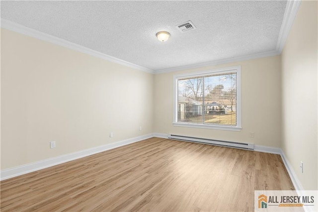 unfurnished room with a textured ceiling, baseboards, wood finished floors, a baseboard radiator, and visible vents