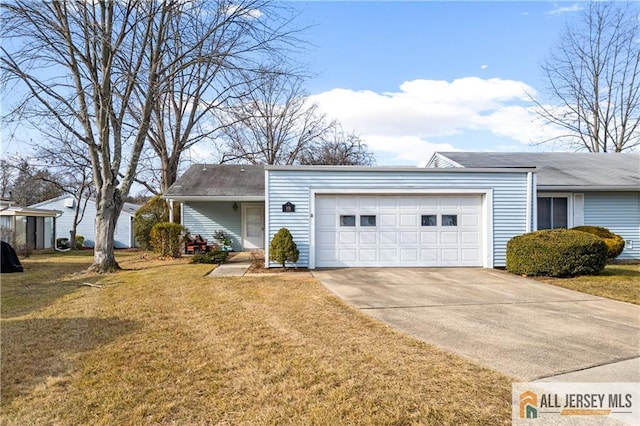 view of front of home featuring an attached garage, driveway, and a front lawn