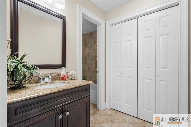bathroom featuring vanity and a closet