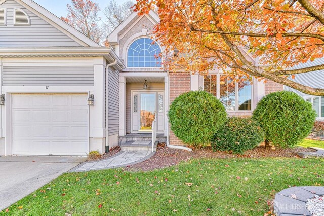 property entrance featuring a yard and a garage