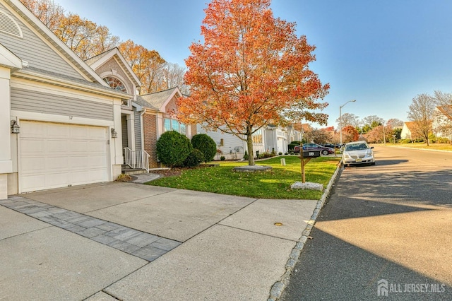 view of front of house featuring a front yard and a garage