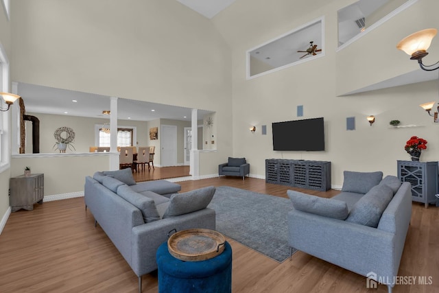 living area featuring recessed lighting, a ceiling fan, baseboards, and wood finished floors