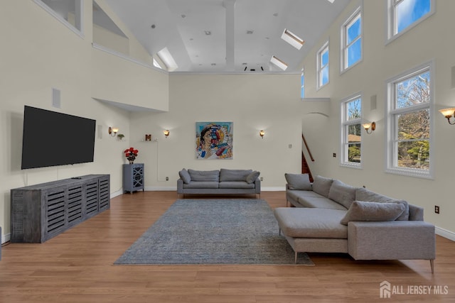 living room featuring stairs, wood finished floors, and baseboards