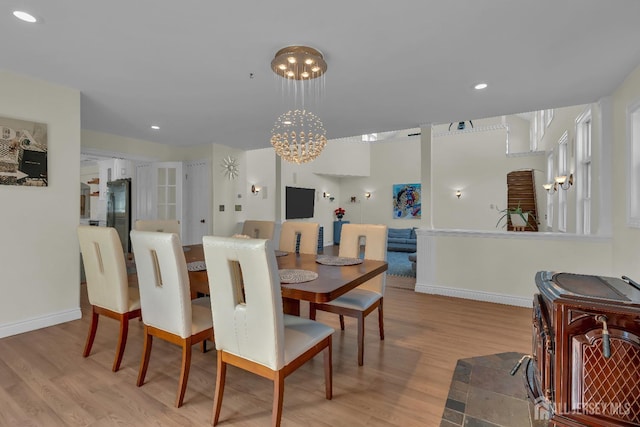 dining space with light wood-style flooring, recessed lighting, and baseboards