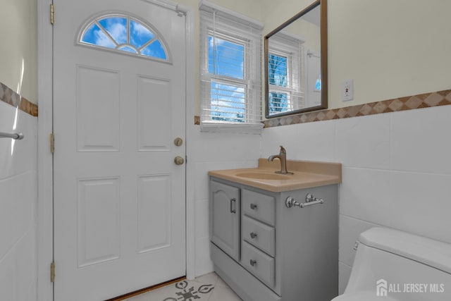 interior space with light tile patterned flooring and tile walls