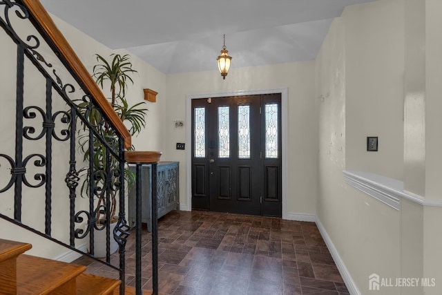 entrance foyer featuring baseboards and stairs