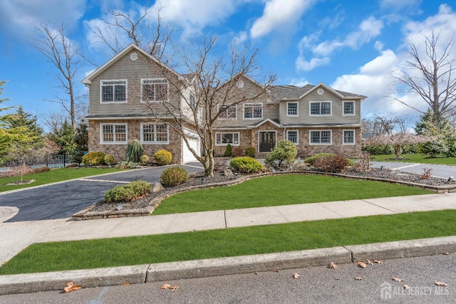896 Kearney Dr, North Brunswick, NJ 08902 - shingle-style home featuring stone siding, an attached garage, a front lawn, and aphalt driveway