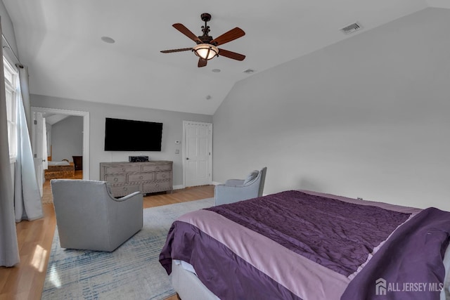 bedroom featuring visible vents, wood finished floors, ceiling fan, and vaulted ceiling