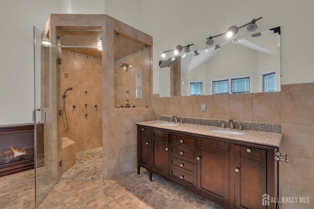 896 Kearney Dr, North Brunswick, NJ 08902 - full bathroom with double vanity, tile walls, tiled shower, and a sink