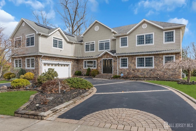 896 Kearney Dr, North Brunswick, NJ 08902 - view of front facade featuring aphalt driveway, an attached garage, stone siding, and a front yard
