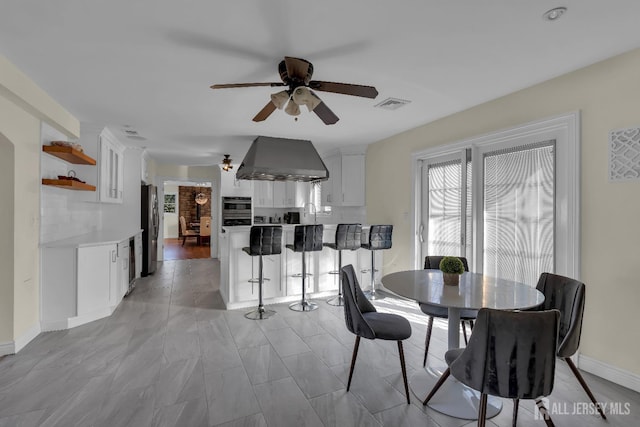 dining area featuring visible vents, baseboards, and a ceiling fan