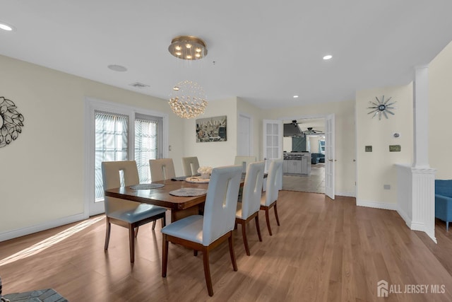 dining space featuring visible vents, ornate columns, light wood finished floors, baseboards, and recessed lighting