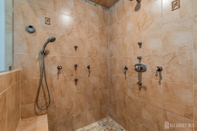 full bath featuring a tile shower