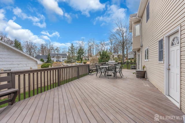 deck featuring outdoor dining space and a residential view