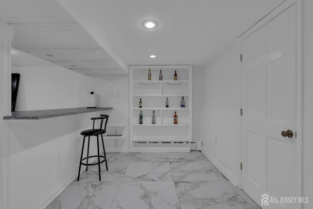 bar with recessed lighting, a baseboard radiator, baseboards, and marble finish floor