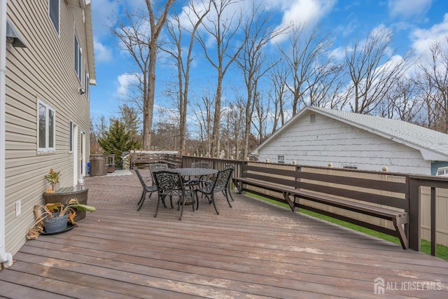 wooden terrace with outdoor dining area