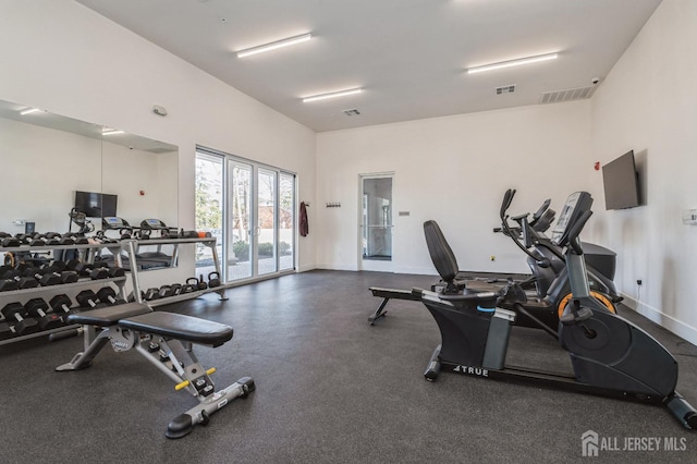 gym featuring baseboards and visible vents