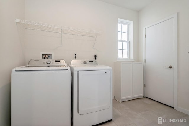 washroom with laundry area and independent washer and dryer