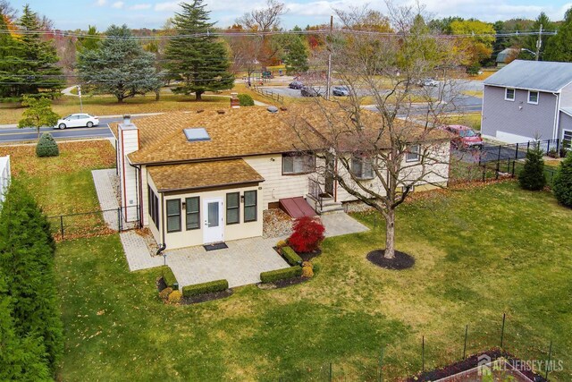 rear view of property with a lawn and a patio area