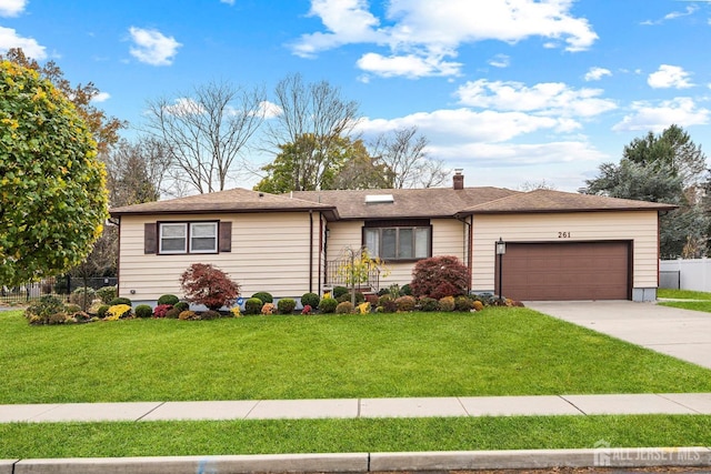 single story home featuring a front lawn and a garage