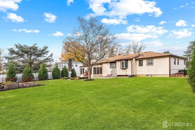 back of property featuring a lawn