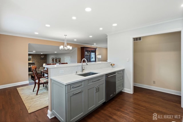 kitchen with sink, kitchen peninsula, gray cabinets, and hanging light fixtures