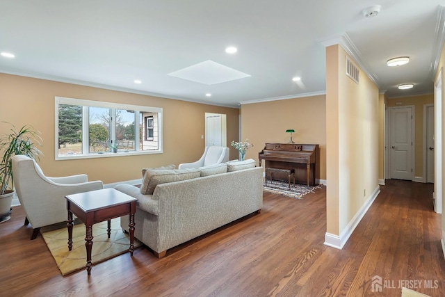 living room with hardwood / wood-style flooring, ornamental molding, and a skylight