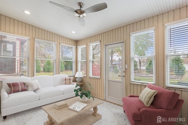 sunroom / solarium featuring ceiling fan and a healthy amount of sunlight