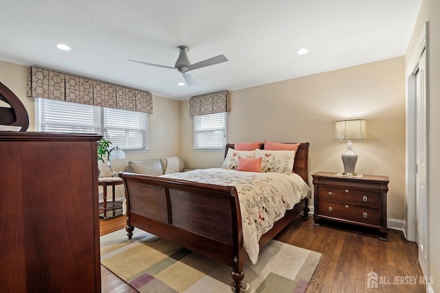 bedroom with dark hardwood / wood-style flooring and ceiling fan