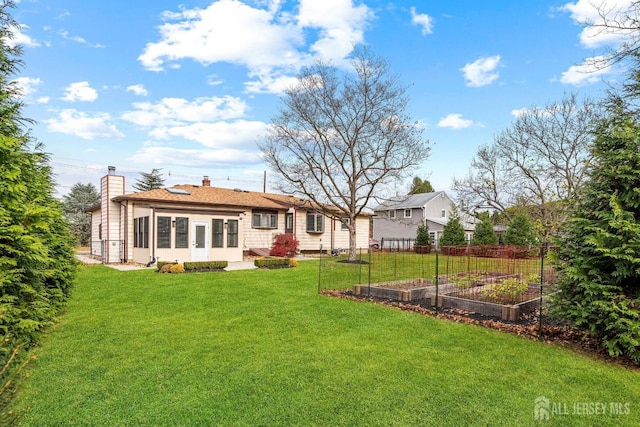 rear view of property with a yard