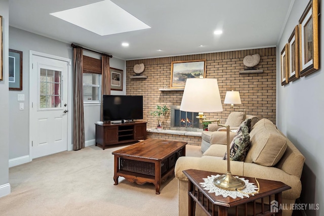 carpeted living room with a skylight, brick wall, and a fireplace