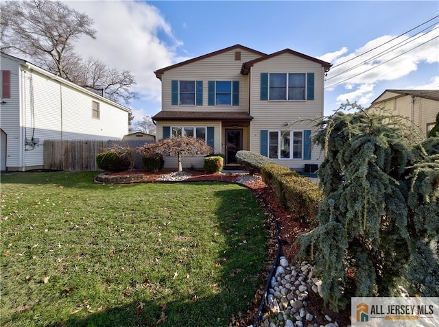 view of front of house with fence and a front yard