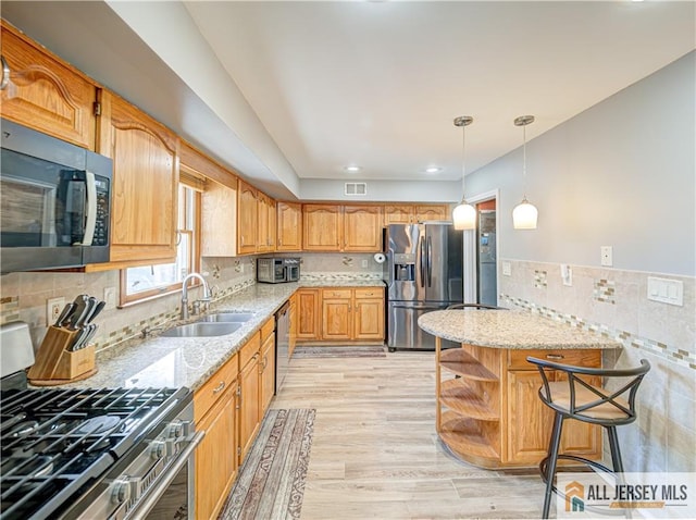 kitchen with open shelves, light stone countertops, stainless steel appliances, pendant lighting, and a sink