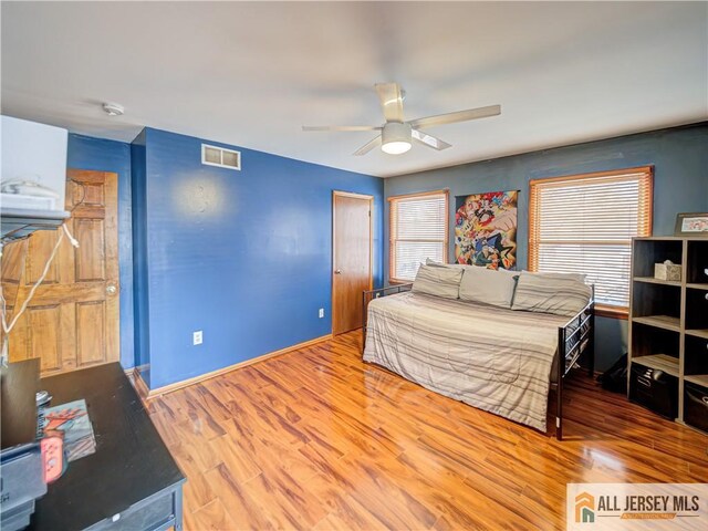 bedroom featuring hardwood / wood-style floors and ceiling fan